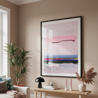 Living room with a framed abstract artwork on the wall, a coffee table with decor items, and a plant.